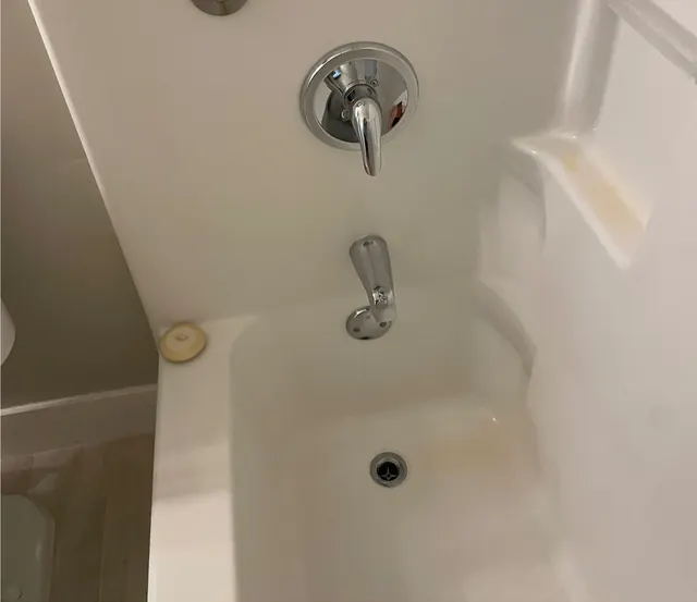 After: The same tub, white, with polished fixtures.