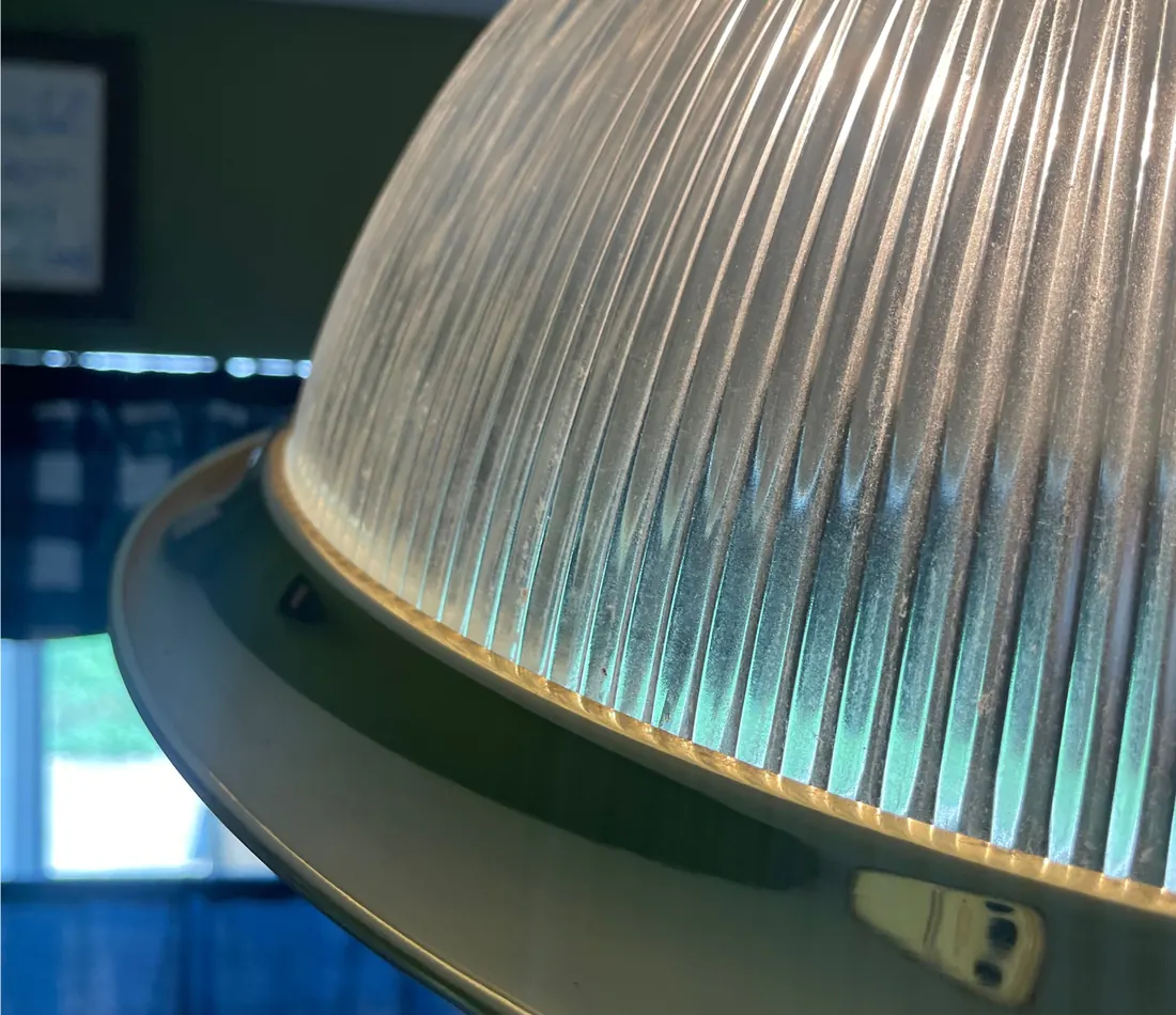 After: The same glass light fixture, clear and catching the light.